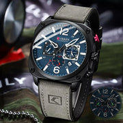Curren watch with blue face and gray strap on a camouflage background