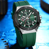 Green watch with detailed face on a blue textured background
