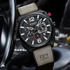 Black wristwatch with gray strap on a blurred background