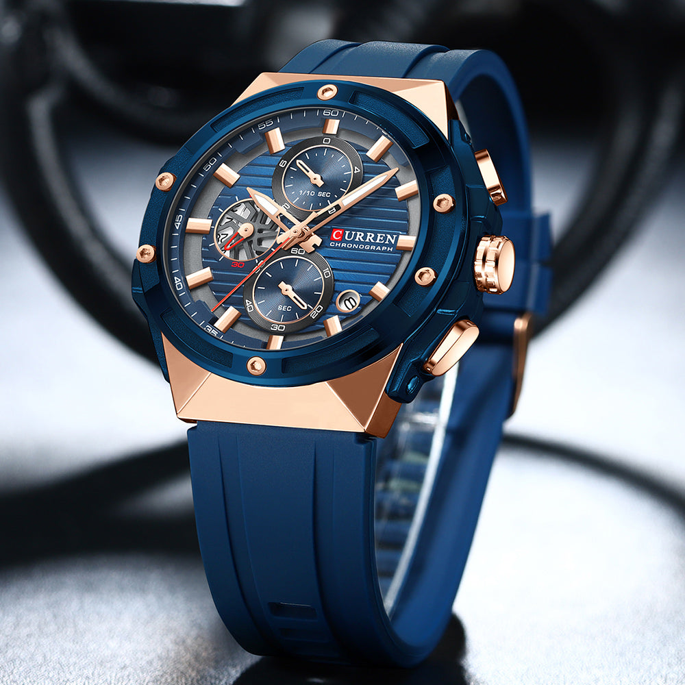 Blue and rose gold watch with 'Curren' brand on a blurred background