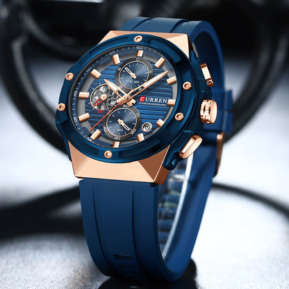 Blue and rose gold watch with 'Curren' brand on a blurred background